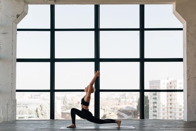 A woman performing yoga to refresh her mind.